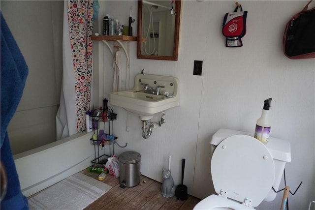 608 W 27th St, Bryan, TX 77803 - full bath featuring wood finished floors, toilet, and a sink