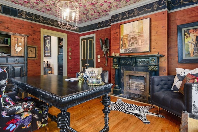 home office featuring wood-type flooring and crown molding