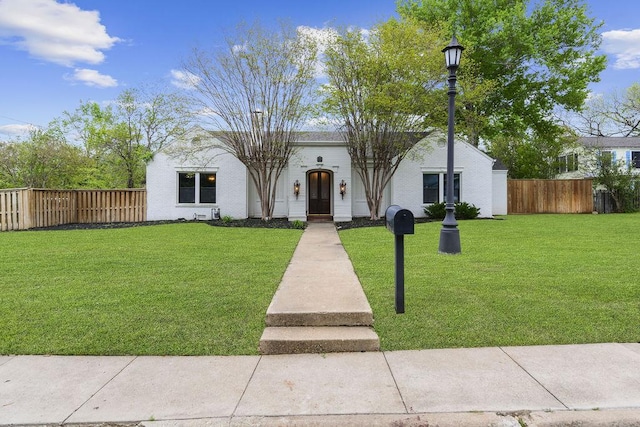 mediterranean / spanish-style house with a front lawn