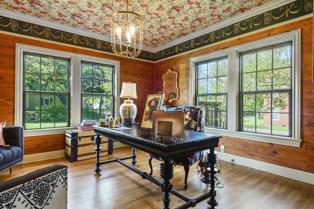 office with a healthy amount of sunlight, ornamental molding, a chandelier, and wood-type flooring