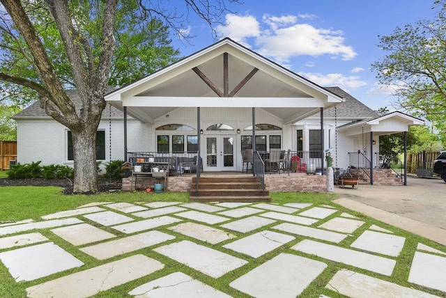 back of house with french doors and covered porch