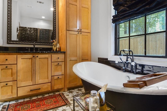 bathroom with a bathtub and vanity