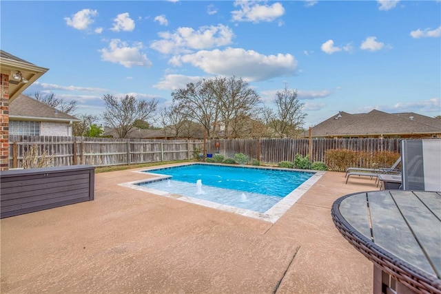 view of swimming pool featuring a patio area, a fenced in pool, and a fenced backyard