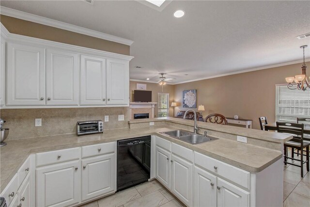 kitchen featuring a peninsula, a sink, black dishwasher, crown molding, and ceiling fan with notable chandelier