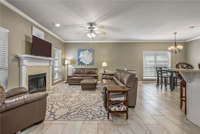 living room featuring visible vents, crown molding, and a tile fireplace