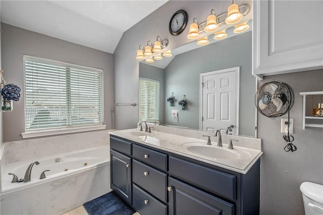 full bath with a sink, lofted ceiling, a jetted tub, and double vanity