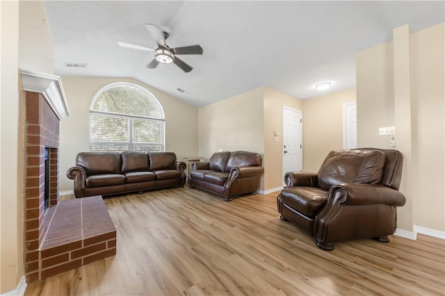 9939 County Road 272, Somerville, TX 77879 - living room with ceiling fan, light wood-style flooring, vaulted ceiling, baseboards, and a fireplace