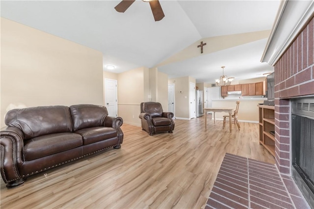 9939 County Road 272, Somerville, TX 77879 - living area featuring lofted ceiling, a chandelier, ceiling fan, light wood-style floors, and a fireplace