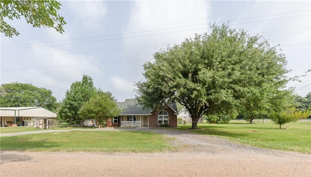 9939 County Road 272, Somerville, TX 77879 - view of front of property with a front lawn, a porch, and gravel driveway