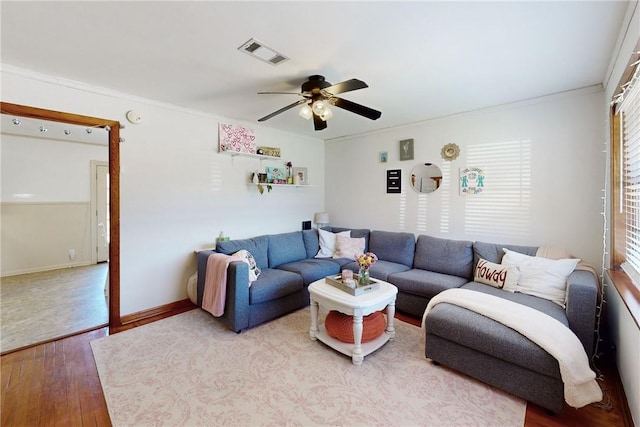 living room featuring hardwood / wood-style flooring, ceiling fan, and ornamental molding