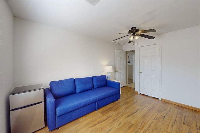 unfurnished living room with light wood-type flooring and ceiling fan