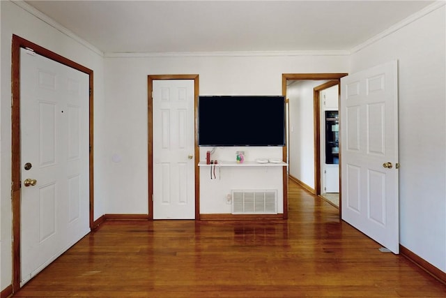 interior space featuring dark wood-type flooring and ornamental molding