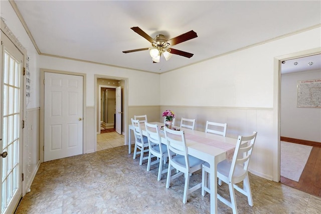 dining area featuring ceiling fan and crown molding