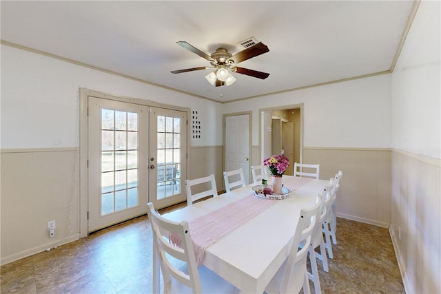 dining room with ornamental molding, ceiling fan, and french doors