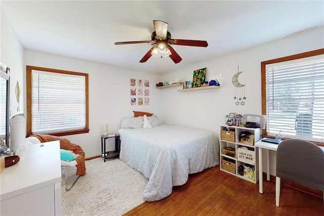 bedroom with ceiling fan and dark wood-type flooring