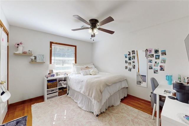 bedroom with ceiling fan and hardwood / wood-style flooring