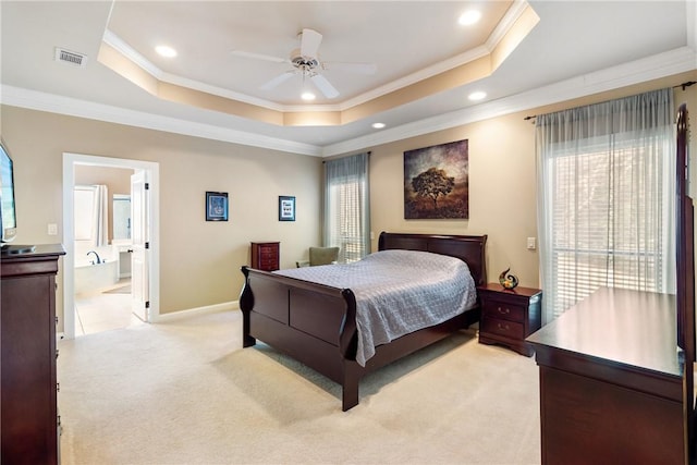 bedroom with light carpet, visible vents, a tray ceiling, and ornamental molding