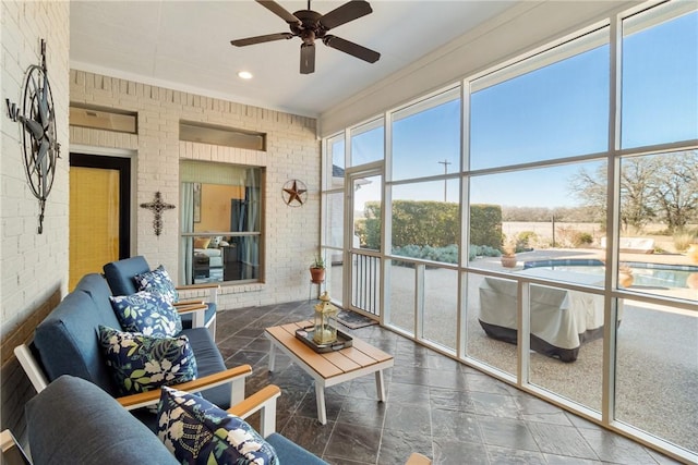 sunroom featuring ceiling fan