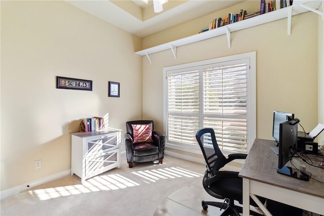 carpeted office featuring baseboards