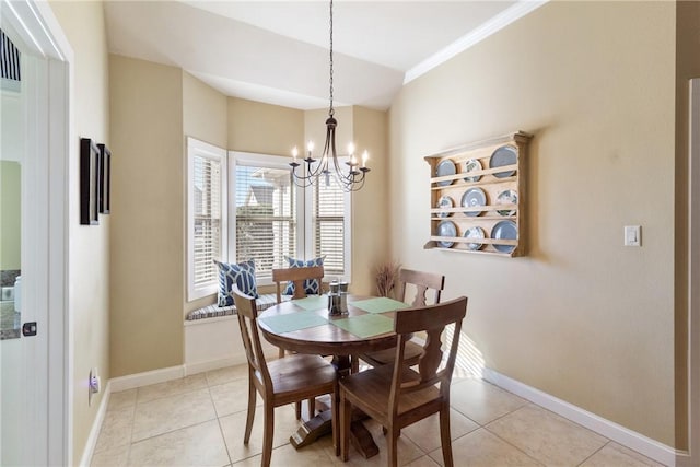 dining room with ornamental molding, light tile patterned flooring, a notable chandelier, and baseboards