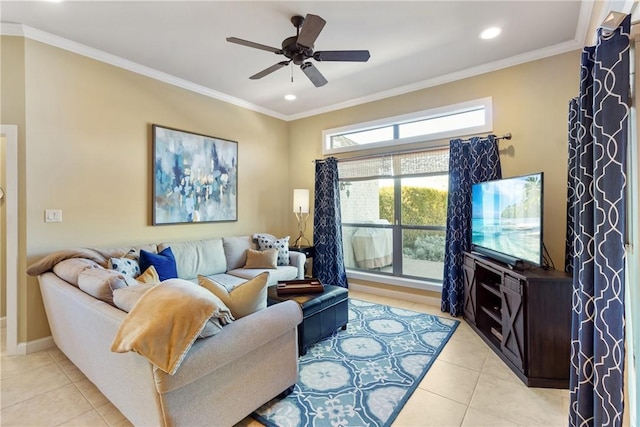 living room with ceiling fan, ornamental molding, baseboards, and light tile patterned flooring