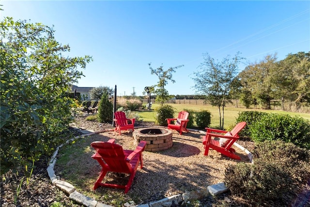 view of yard featuring an outdoor fire pit and fence