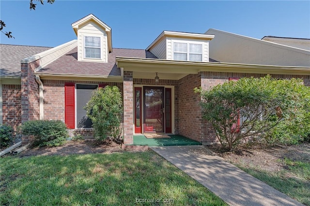 property entrance with a lawn