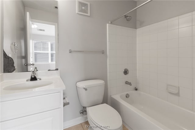 full bathroom featuring tile patterned flooring, vanity, toilet, and tiled shower / bath