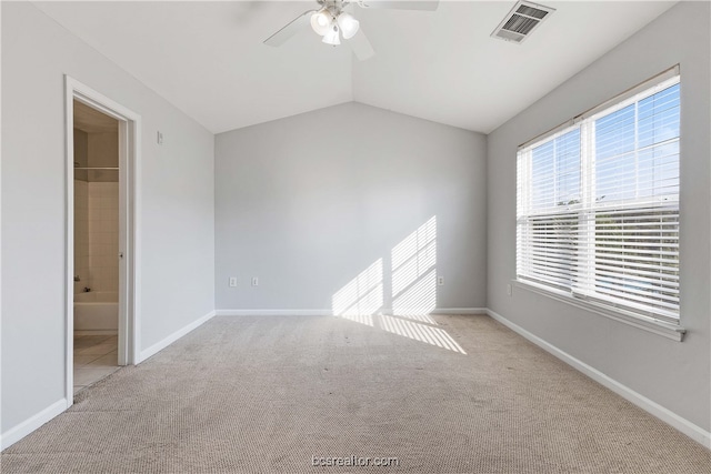 unfurnished room with ceiling fan, light carpet, and vaulted ceiling