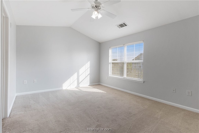 empty room with ceiling fan, light carpet, and vaulted ceiling