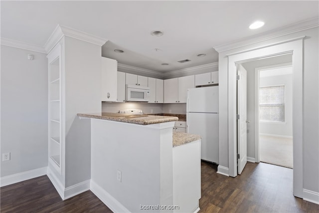 kitchen with dark hardwood / wood-style floors, kitchen peninsula, white appliances, white cabinets, and ornamental molding