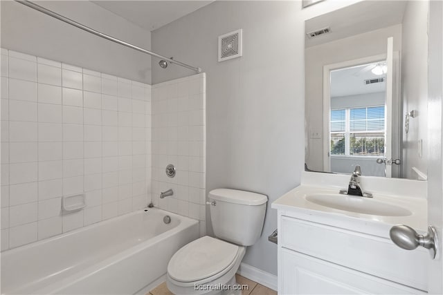 full bathroom featuring vanity, toilet, and tiled shower / bath