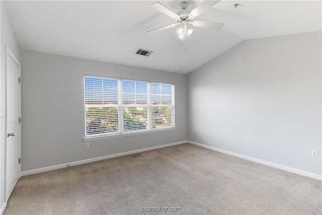 carpeted empty room featuring ceiling fan and lofted ceiling