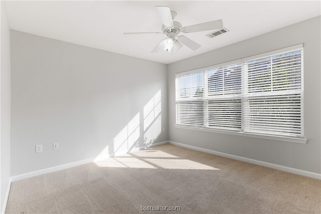 carpeted spare room with ceiling fan