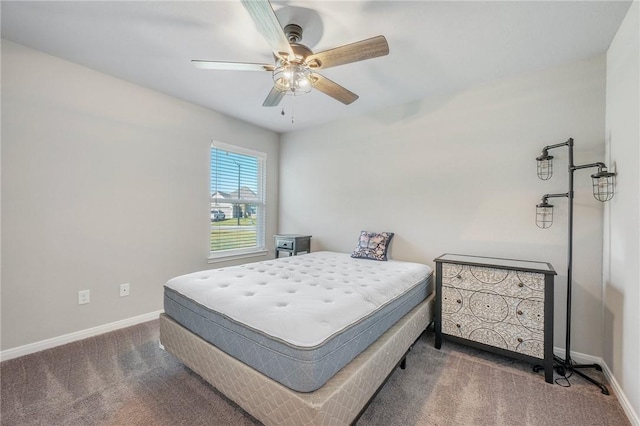 bedroom featuring ceiling fan and dark carpet