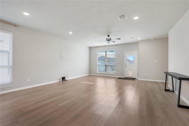 empty room featuring ceiling fan and light hardwood / wood-style floors