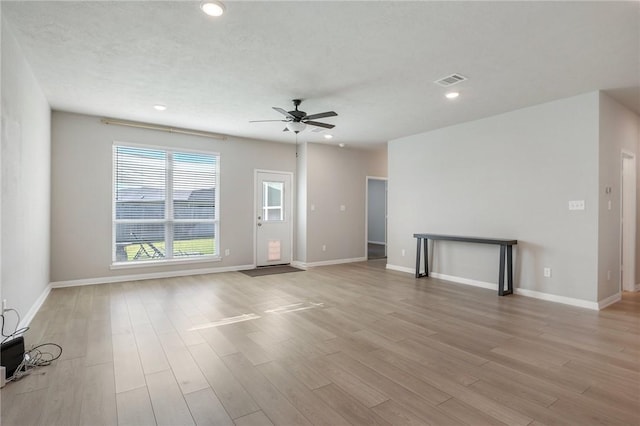 unfurnished living room with ceiling fan and light hardwood / wood-style flooring