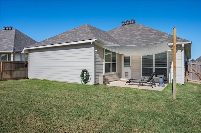 rear view of property featuring a yard and a patio