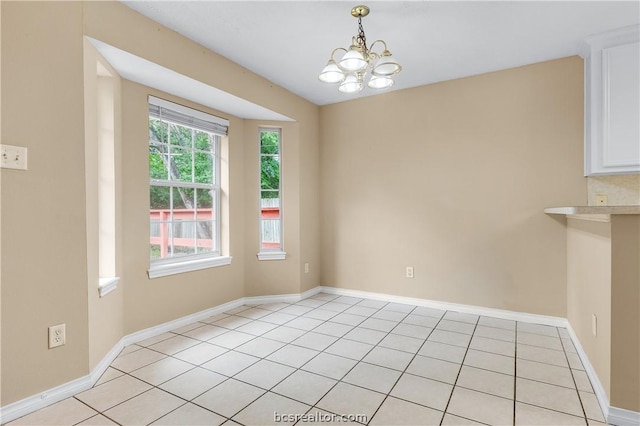 unfurnished dining area with a notable chandelier and light tile patterned flooring