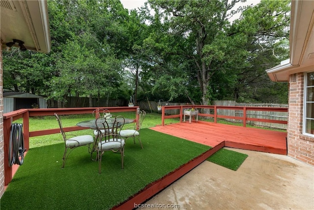 view of yard with a storage unit and a deck