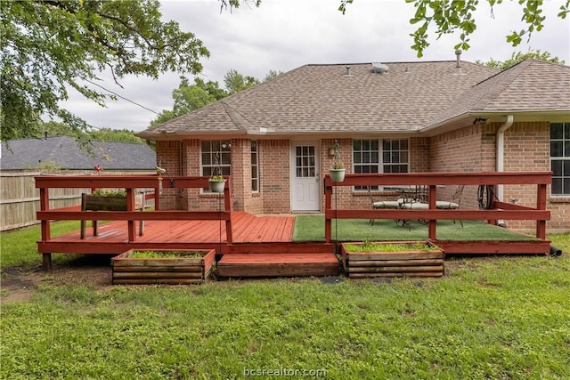 back of property with a lawn and a deck