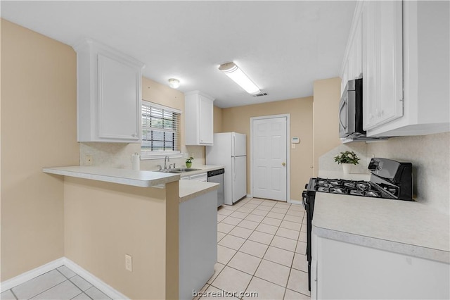 kitchen with white cabinetry, sink, stainless steel appliances, kitchen peninsula, and light tile patterned flooring