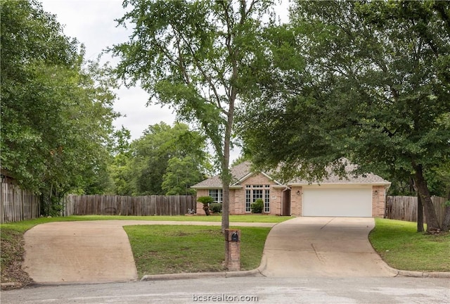 view of front of house featuring a garage and a front yard