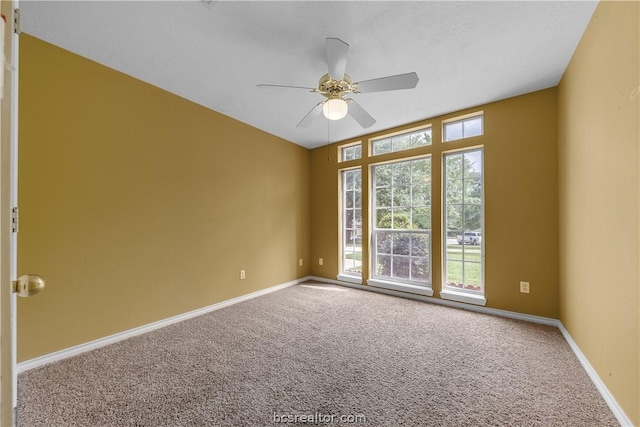 carpeted spare room featuring ceiling fan