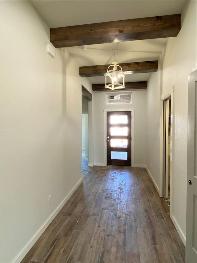 hall featuring beam ceiling, a notable chandelier, and dark hardwood / wood-style flooring