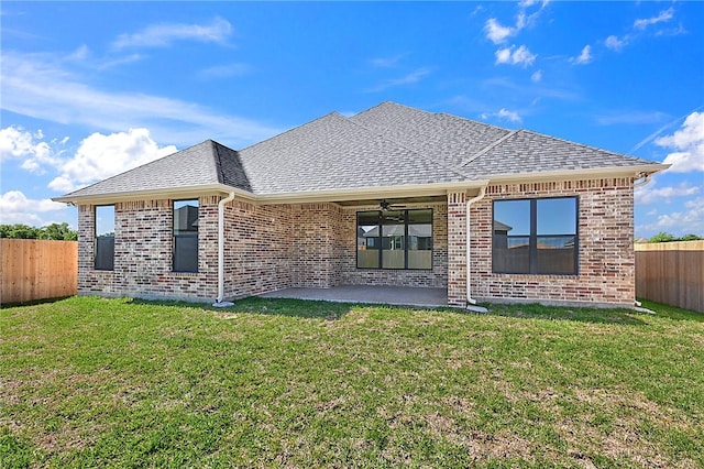 rear view of house with a patio area and a yard