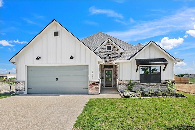 view of front of home with a front lawn and a garage