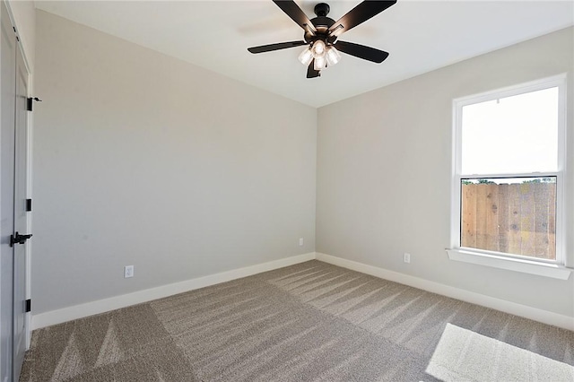 empty room featuring carpet floors and ceiling fan