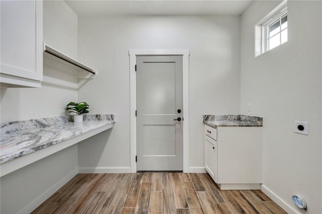 laundry area with baseboards, light wood finished floors, and hookup for an electric dryer