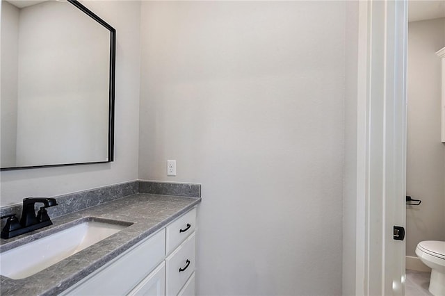 bathroom featuring tile patterned flooring, vanity, and toilet